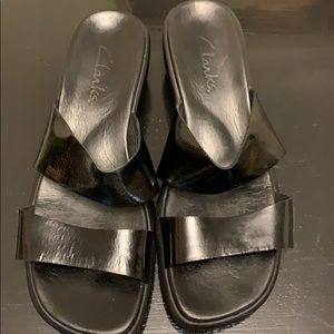 Black sandals with double patent leather straps.